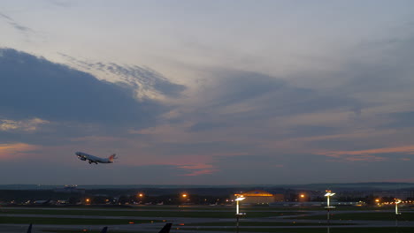 passenger airplane taking off in the dusk