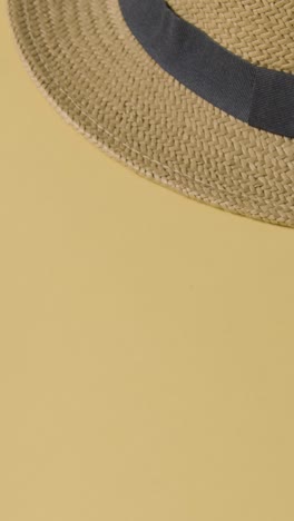 Vertical-Video-Summer-Holiday-Concept-Of-Hand-Picking-Up-Sun-Hat-Sunglasses-On-Beach-Towel