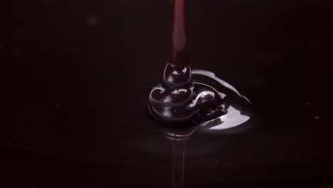 swirling liquid in dark background, close-up shot of fluid's motion and shape