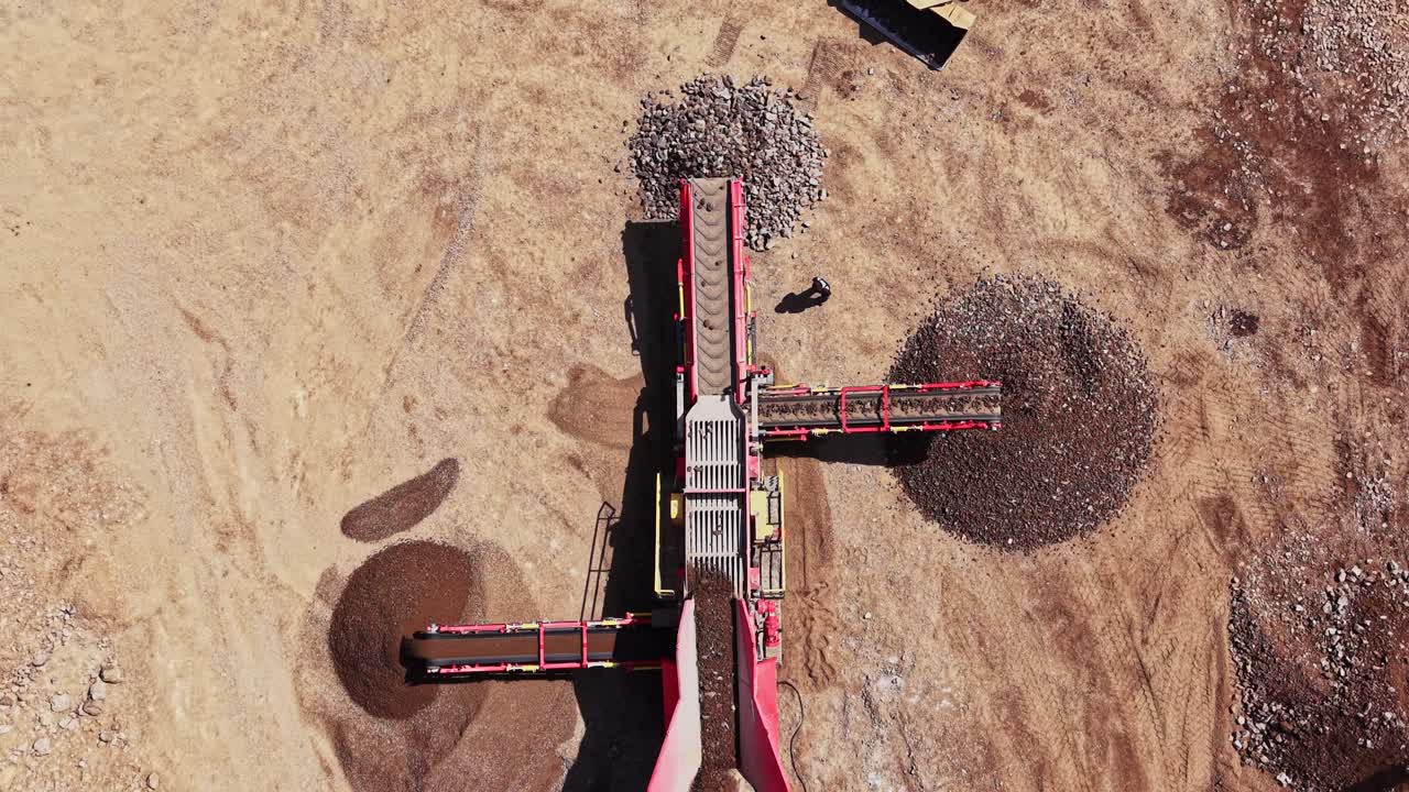 Heavy machinery works on a quarry site during daylight hours