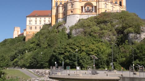 Tilt-down-over-famous-Stift-Melk-Abbey-in-Wachau,-Austria-on-clear-day