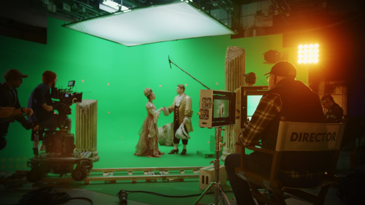 On Big Film Studio Professional Crew Shooting History Costume Drama Movie. On Set: Director Controls Cameraman Shooting Green Screen Scene with Two Actors Talented Wearing Renaissance Clothes Talking