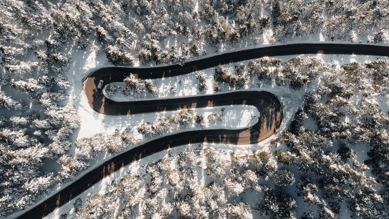 Mount Parnassus mountain winding road covered in snow winter in Greece, aerial drone top down view