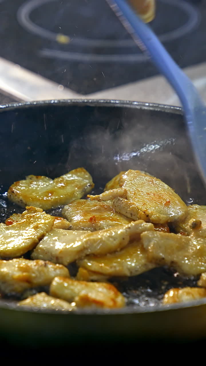 Close up of frying in pan. Chef cooking food in large pan at restaurant. Vertical video