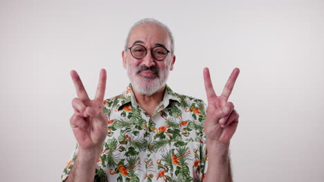 senior man in hawaiian shirt making peace sign