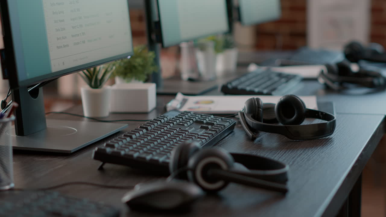 Empty call center office with computers and audio headsets