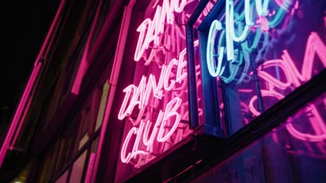glowing neon lights illuminating a dance club sign on a building exterior, creating an energetic and vibrant atmosphere that captures the essence of urban nightlife