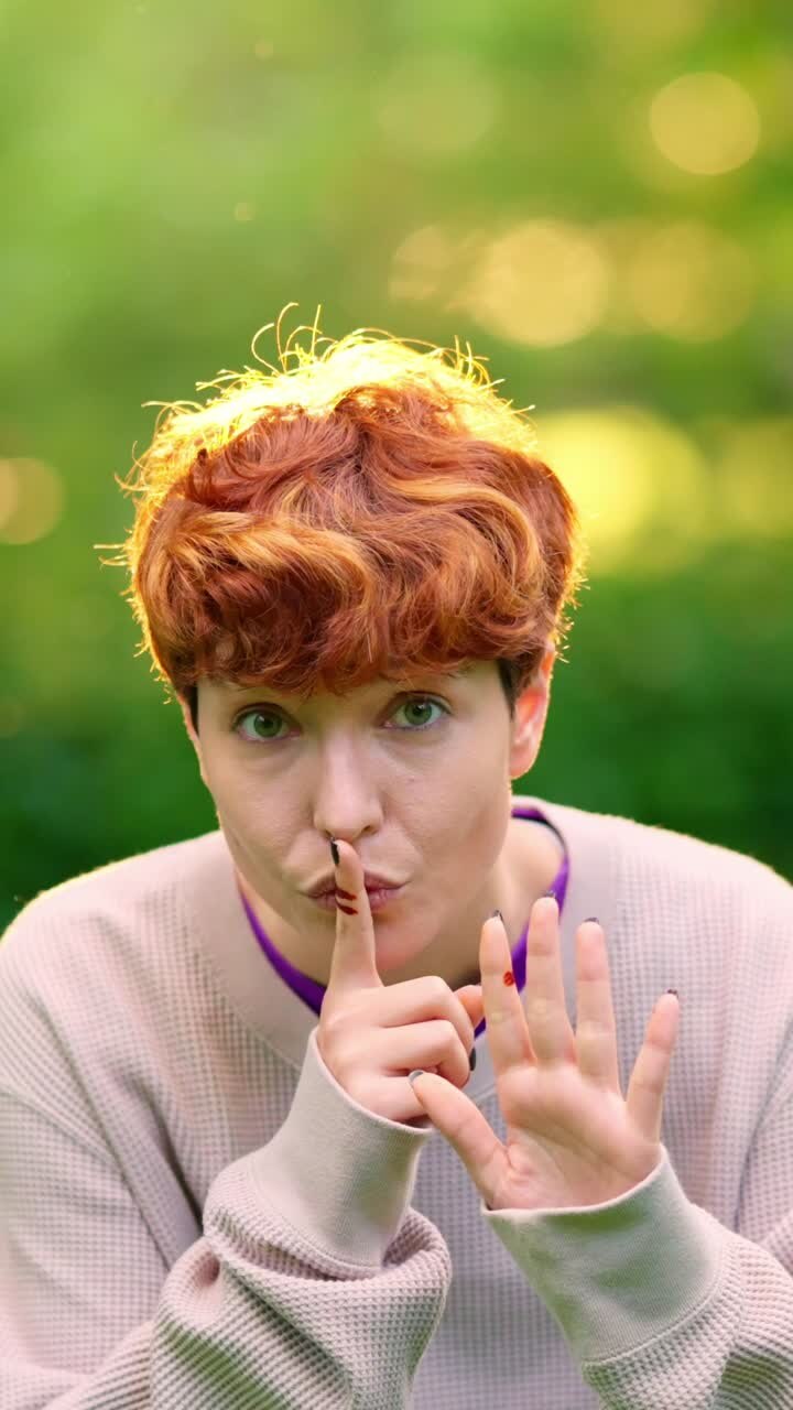 Woman making a shush gesture and holding up four fingers