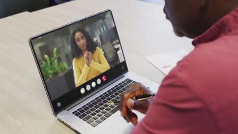 Animation-of-african-american-man-having-video-call-on-laptop