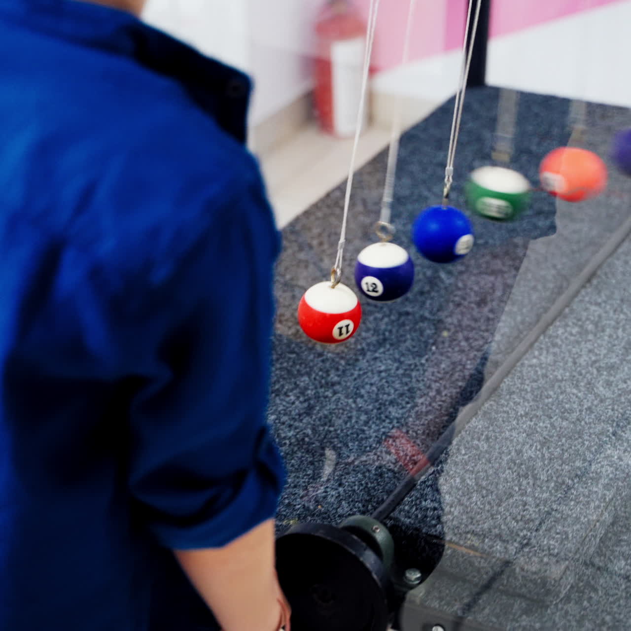 Newton's cradle showing laws of physics in motion. Museum of Science