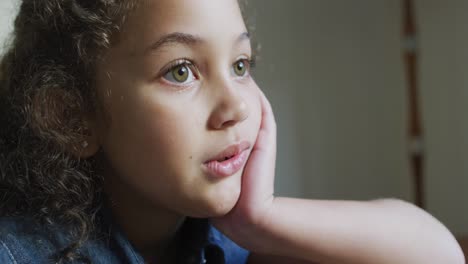 mixed race thoughtful woman, sitting in living room