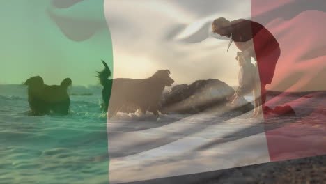 animation of italian flag over caucasian father and child with dogs on sunny beach