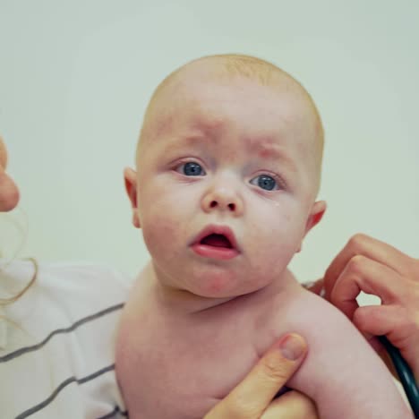 doctor examining baby in hospital