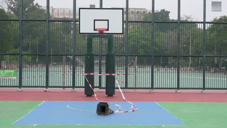 an empty colorful basketball court is seen at a closed playground due to covid-19 coronavirus outbreak and restrictions in hong kong