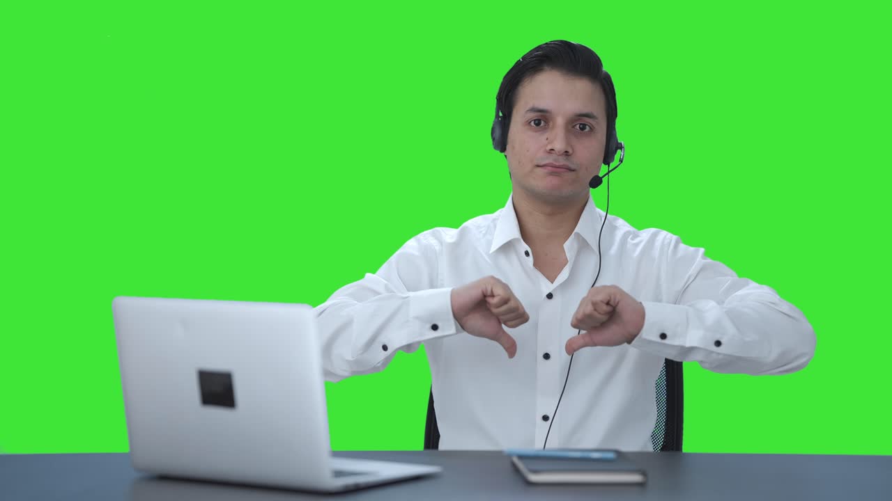Disappointed Indian call center employee showing thumbs down Green screen