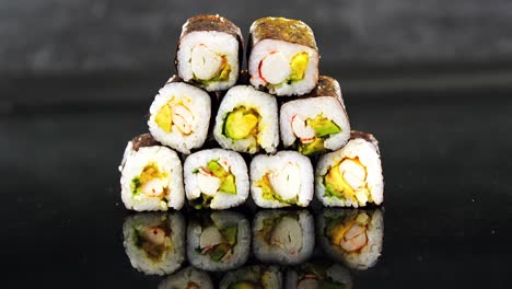 Stack-of-maki-sushi-on-black-background