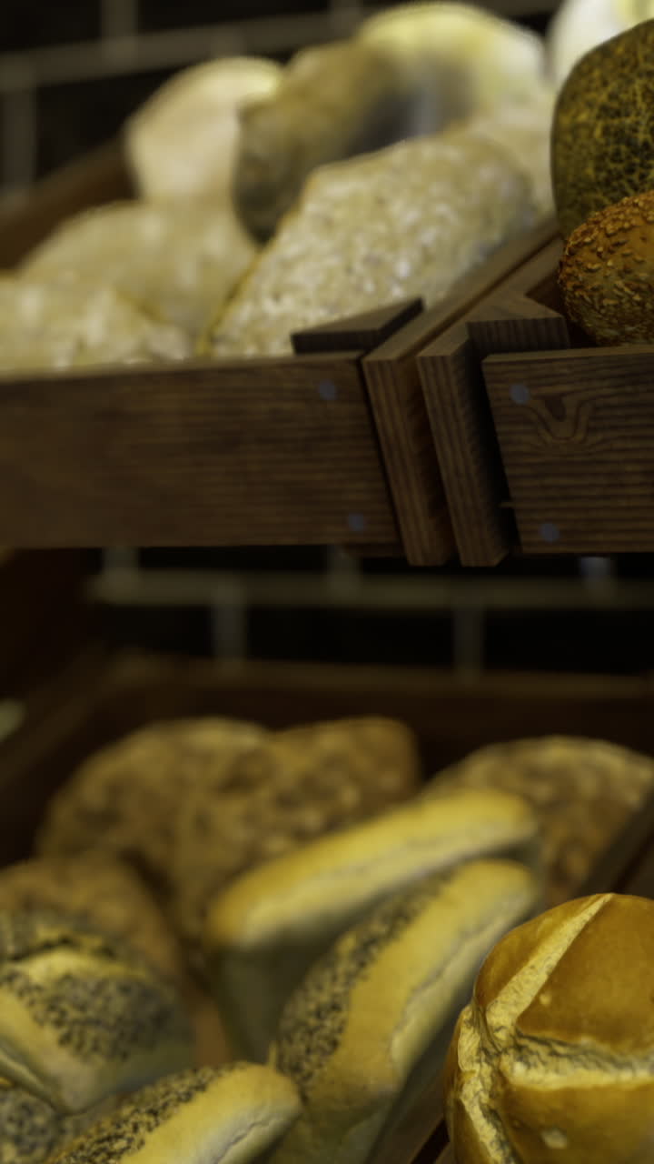 Fresh artisan bread displayed on wooden racks in a bakery setting