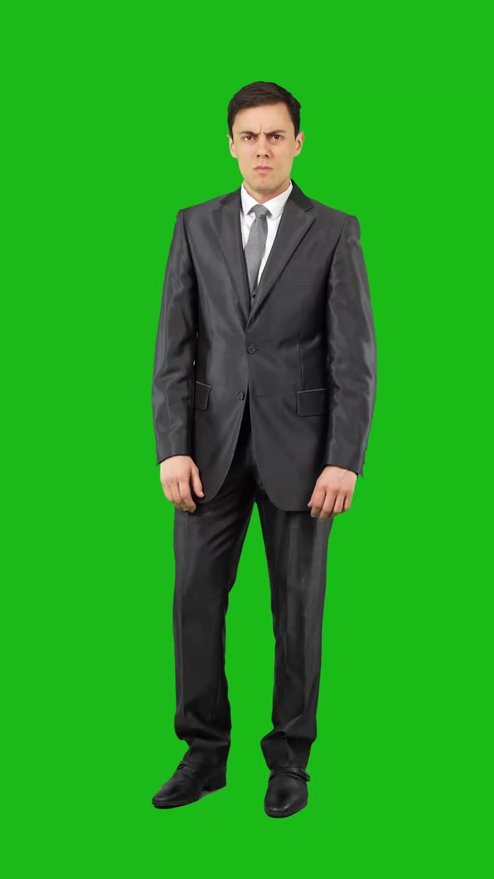 Businessman showing different annoyed and disgruntled expressions on green screen