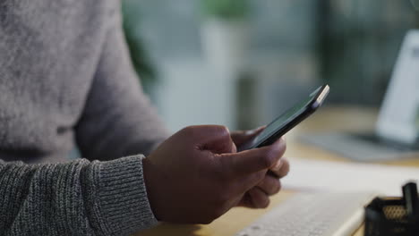 man using a smartphone at his desk