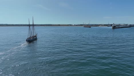 drone clip showing traditional tall ship sailing into harbour