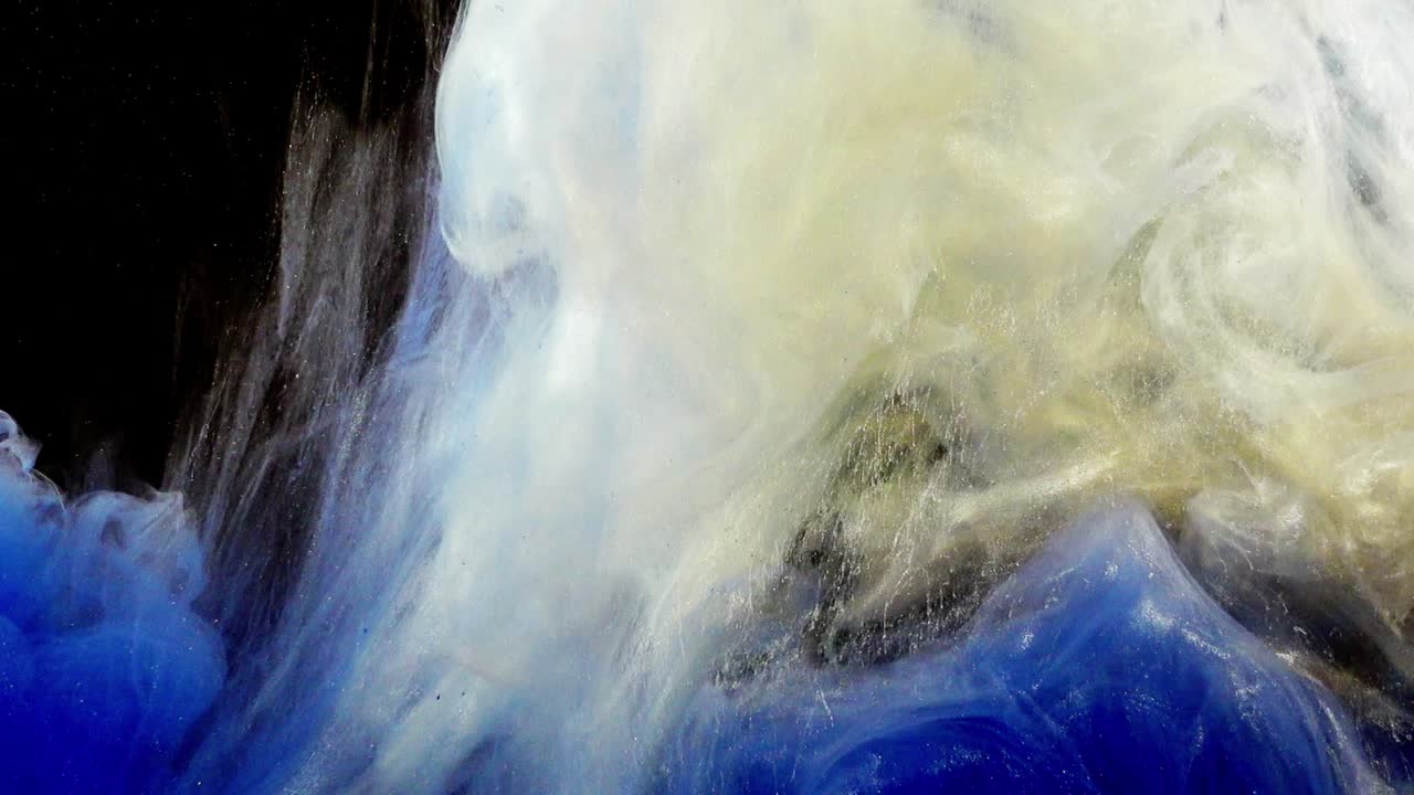 Abstract forms. Shooting on a black background. Mixing of paints