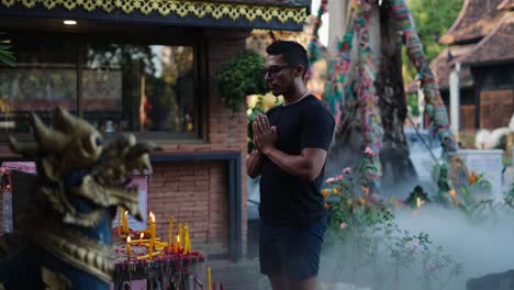 man praying at a thai temple