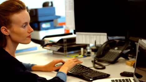 Female-executive-working-at-desk