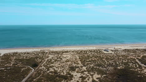 White-Sand-At-The-Seashore-Of-The-Blue-Waterscape-Of-Altura-Beach-In-Portugal