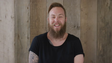 young hipster punk man with beard laughing cheerful enjoying successful lifestyle handsome independent male tattoo