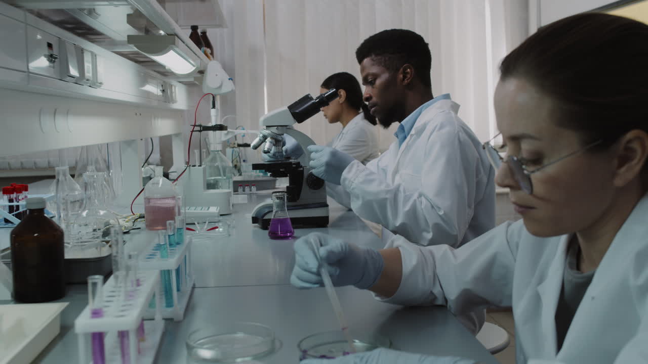 Three Chemists Working on Research in Lab