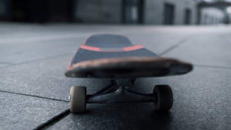 skateboard riding outdoor. closeup skate stopping in middle of sidewalk.