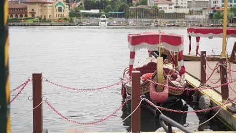 red gondola docked at a lake