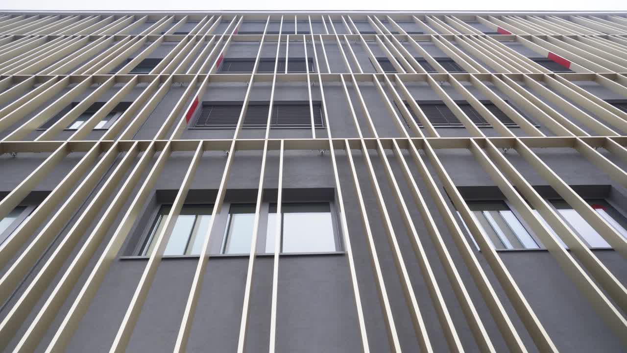 slow establishing shot of vertical architecture running up a building