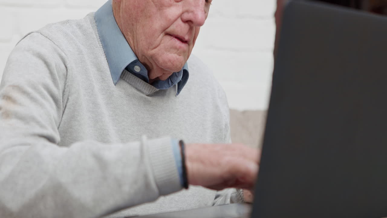 Elderly man using a laptop