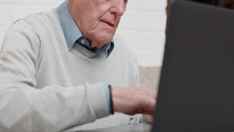 elderly man using a laptop