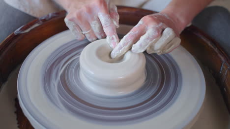 woman working on pottery wheel