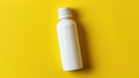 white bottle on yellow background for product mockup