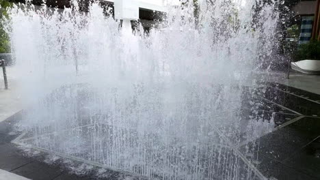 dancing up and down a water fountain is in clear view for everyone to see in the middle of a community mall in bangkok, thailand