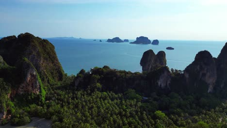 stunning aerial view of phra nang railay beach in krabi, thailand, showcasing its turquoise waters, limestone cliffs, and lush vegetation. unbelievable aerial view flight rotation to right drone