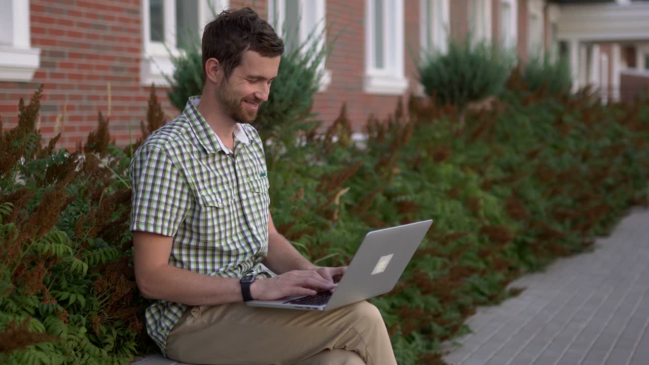 Man working on laptop outdoors