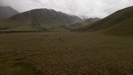 Rugged-mountains-touching-low,-heavy-clouds