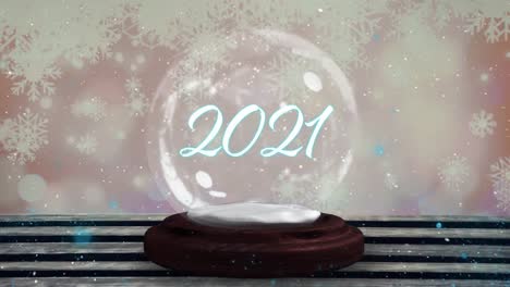 Blue-shooting-star-around-2021-text-over-a-snow-globe-on-wooden-plank