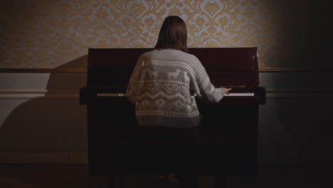 woman playing piano in a classic room