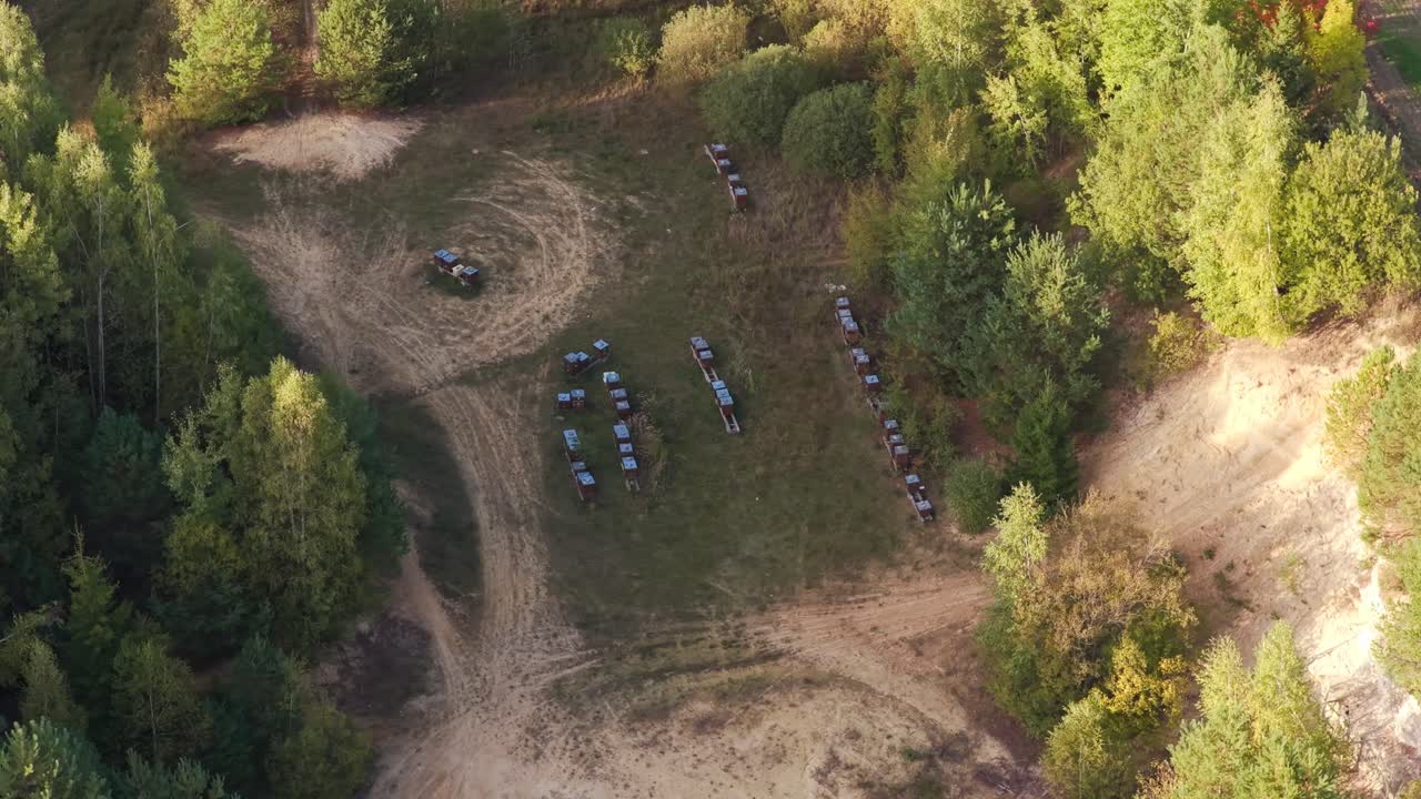 Abandoned sandstone quarry with old beehives surrounded by nature, captured from a drone. Blend of wilderness and human traces in a quiet, rural landscape. Czech Republic