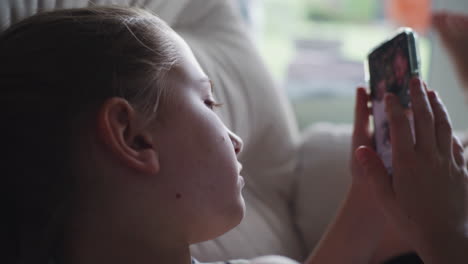 girl using smartphone on couch