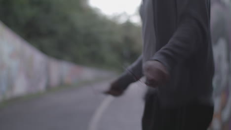 close up shot of young athletic man's hands jumping rope - skipping in an underpass - ungraded