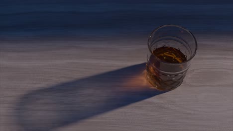 glass of whiskey on wooden table