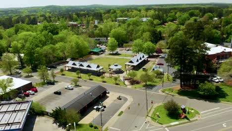 drone orbit left of small town usa park in downtown carrboro north carolina in the summer