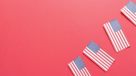 four national flags of usa lying on red background with copy space