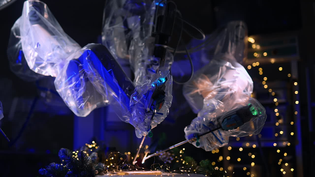 Advanced surgical technology in modern clinics. Da Vinci robot arms write with old writing pen on operational table. Dark surgical room backdrop with Christmas decorations.